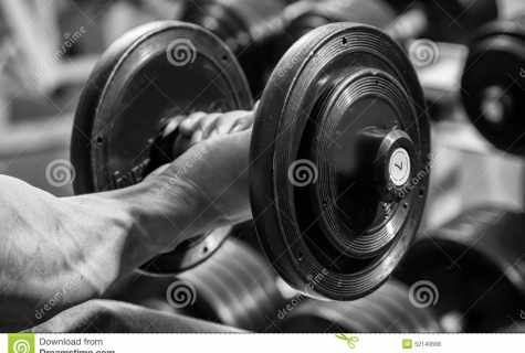 As athletes pump up hands by means of dumbbells