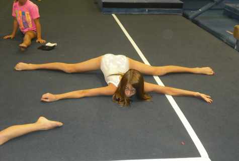 As girls stretch in gymnastics
