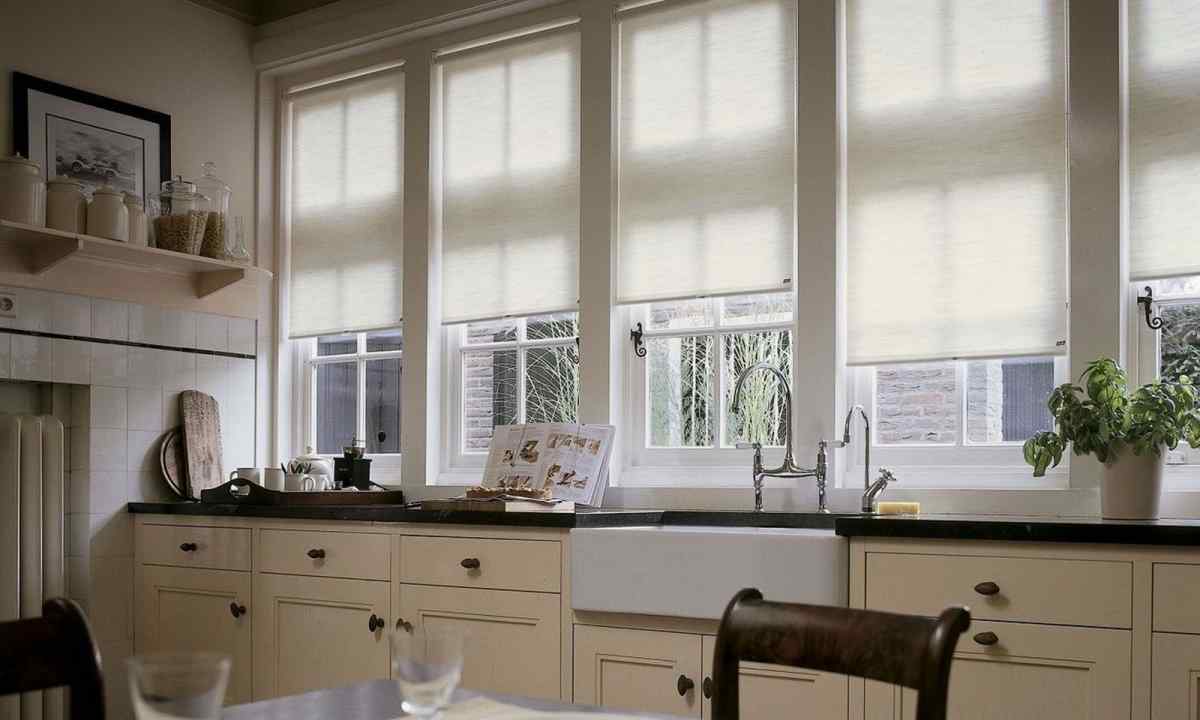 Rolled curtains in interior of kitchen