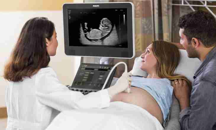 As the child looks on ultrasonography