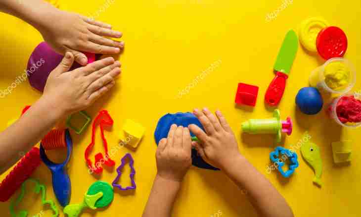 Hand-made articles from plasticine the hands for development of the kid