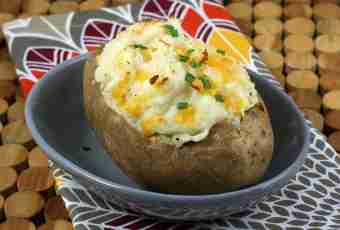 The baked potato with cheese and greens in the multicooker