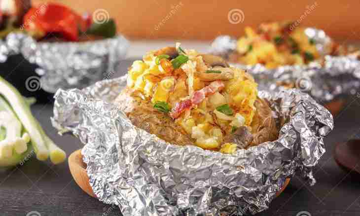 The meat baked in a foil with mushrooms